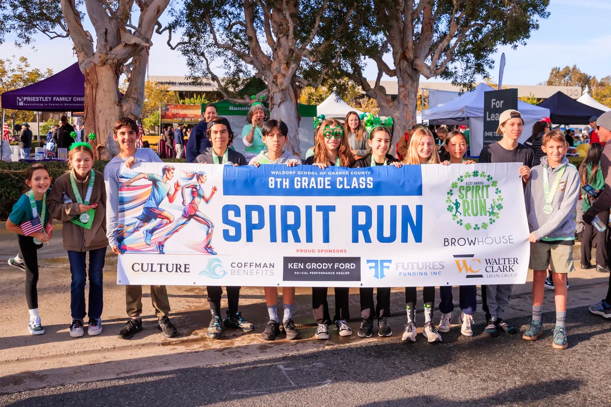 A school team gathered behind their Spirit Run banner at the Newport Spirit Run finish festival