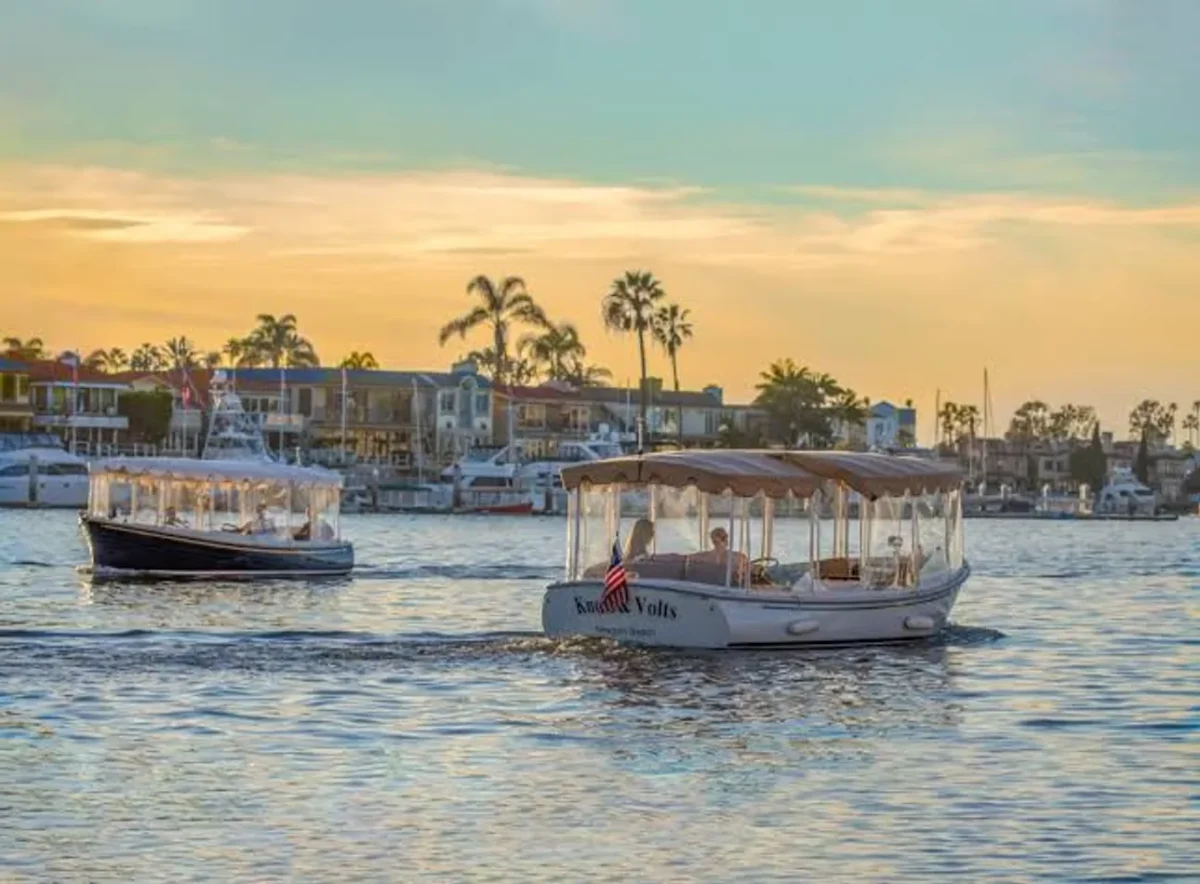 Duffy electric boats cruising Newport Harbor at sunset in Newport Beach